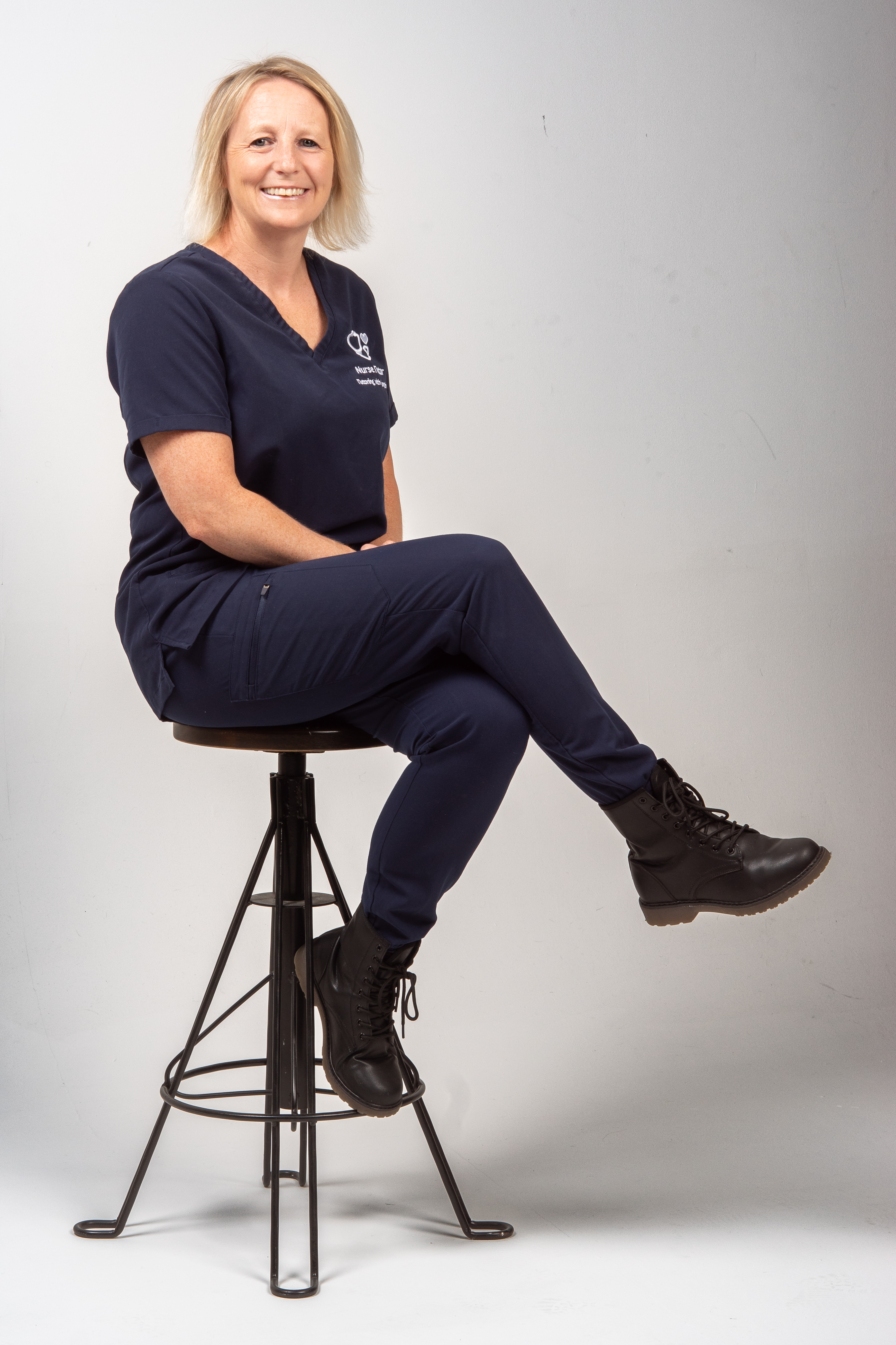 Hannah Ames sitting on a chair facing left in her uniform