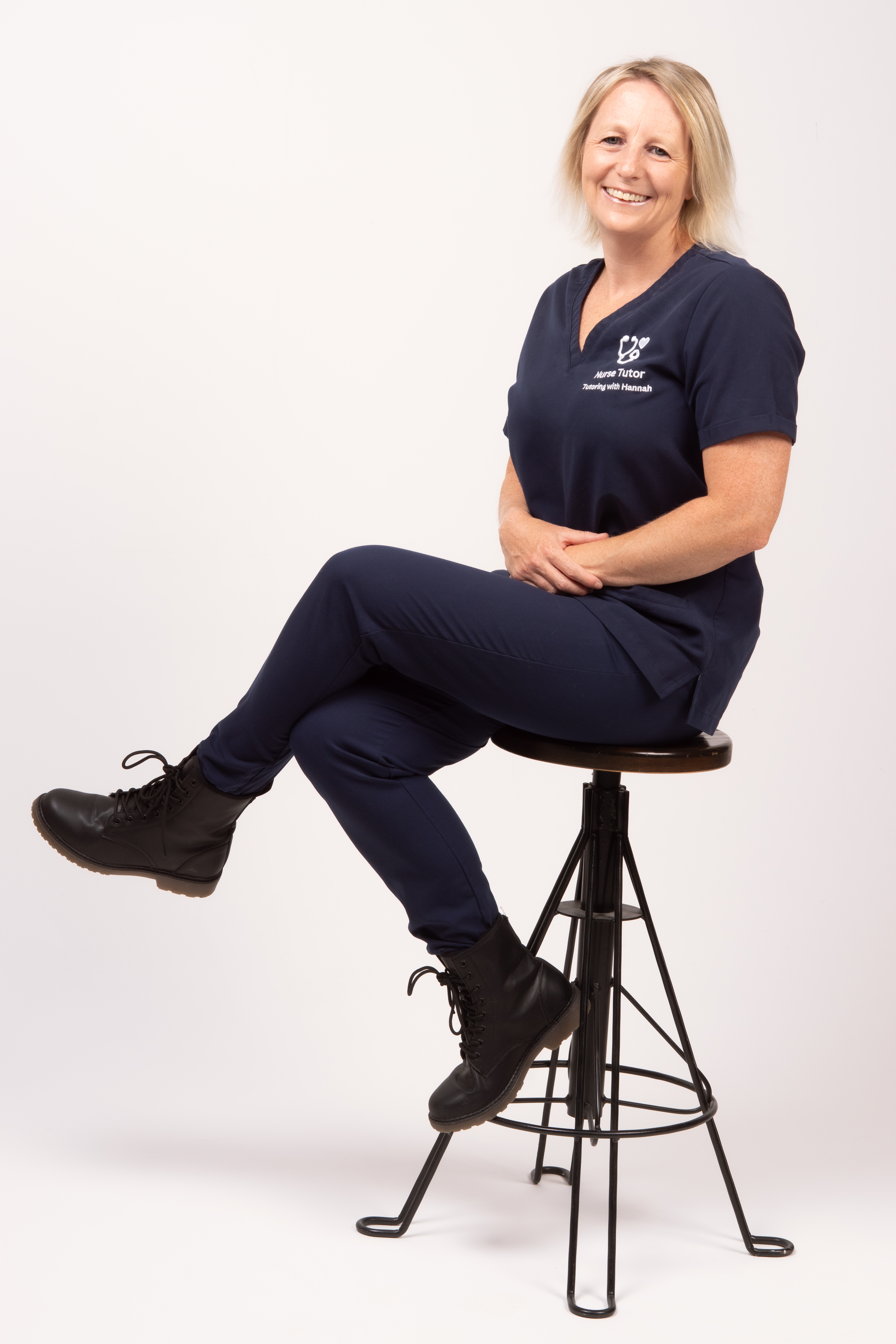 Hannah Ames sitting on a chair in her uniform facing to the right